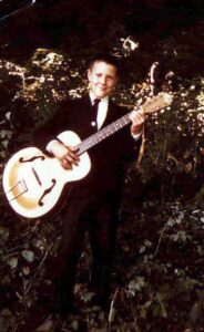 Howard at 6 years, with his first guitar